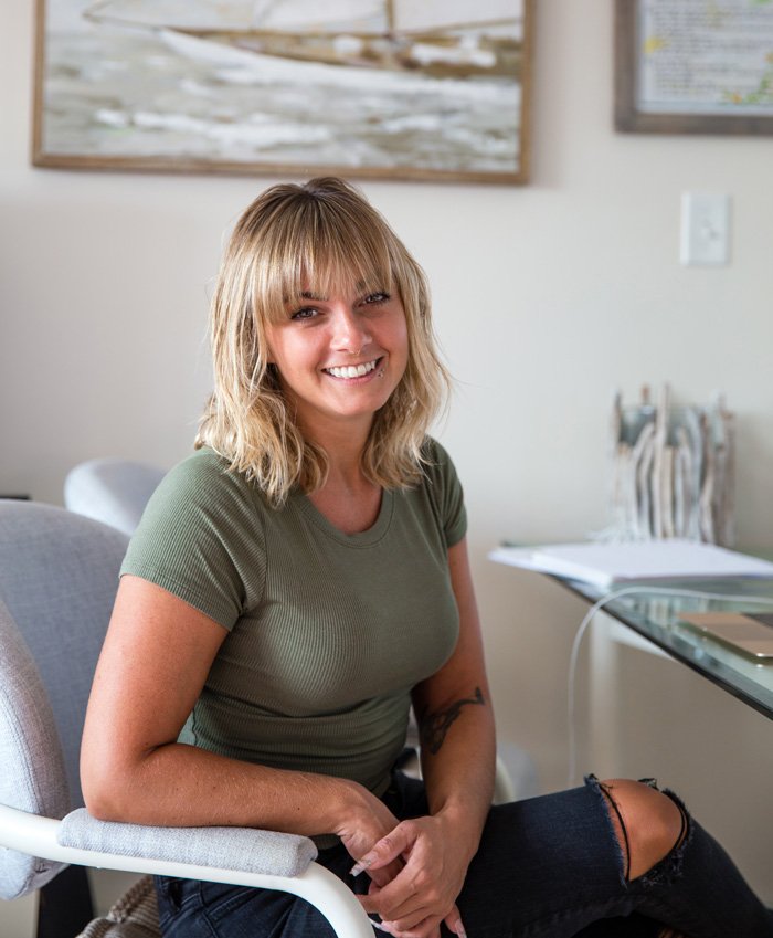 Photo of Ashley sitting down at a desk